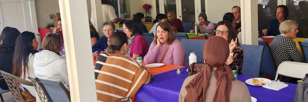 Picture of two people talking at table on patio