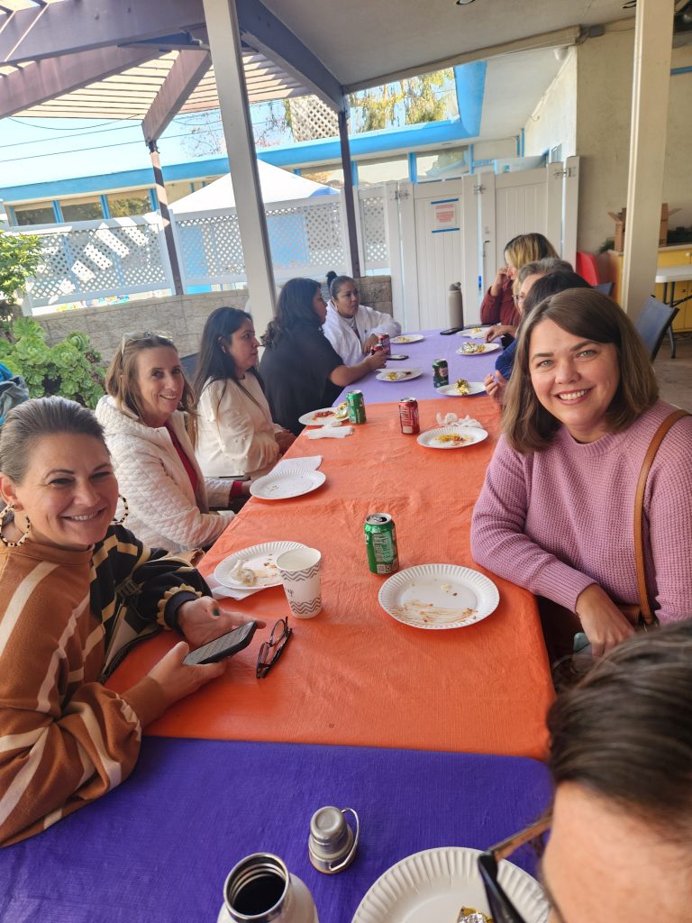 Posed picture at the tables on the patio of workshop attendees