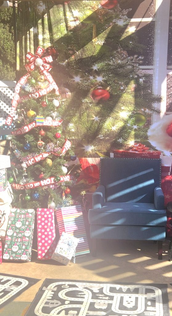 Picture of the tree with gifts and a chair for santa