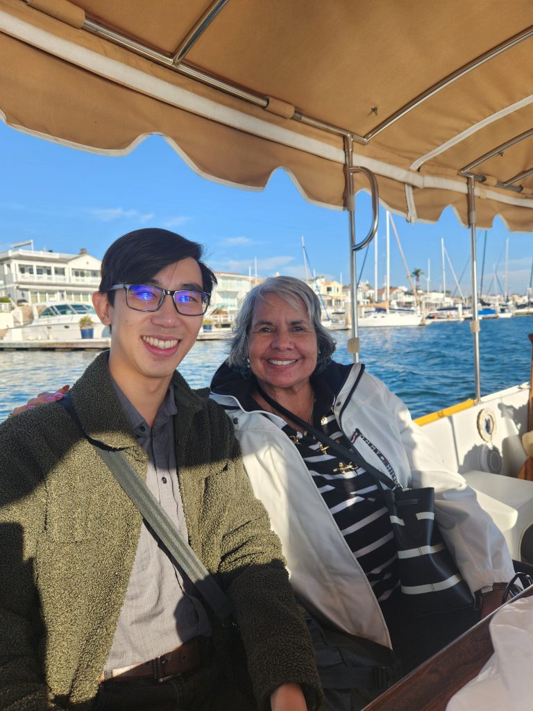 Picture of 2 people on a covered boat.